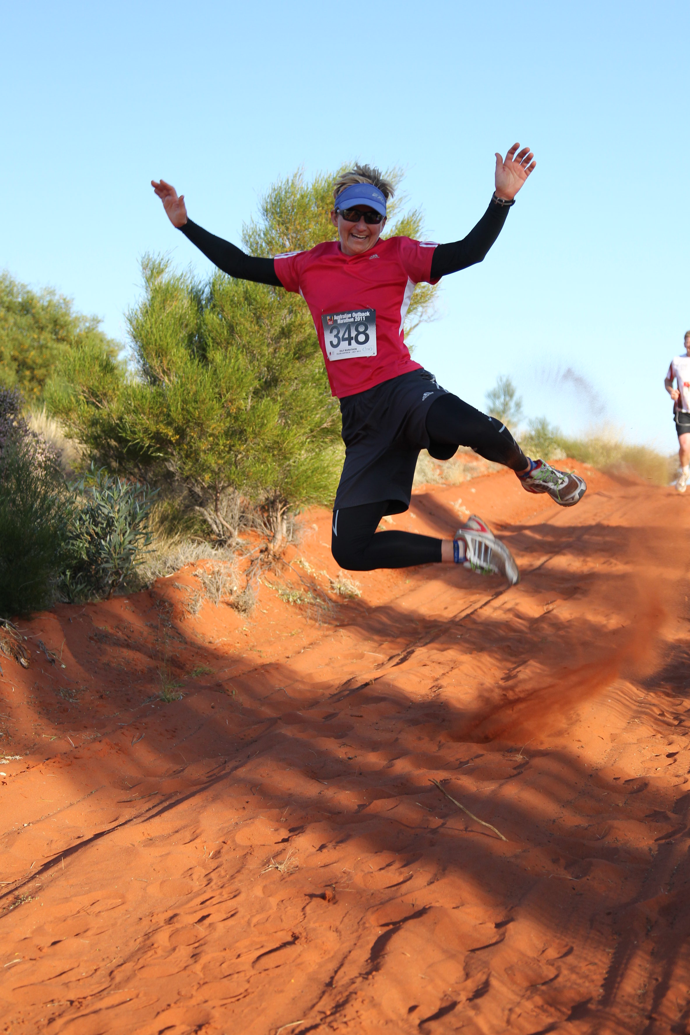 A woman jumps while running the Australia Outback Marathon